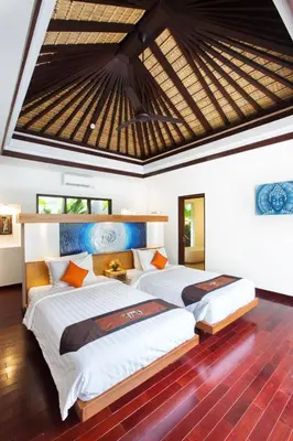 two beds in a bedroom with a roof at Sunset Paradise Villa Jimbaran 8008 in Jimbaran