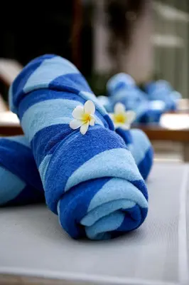 a blue towel with white flowers on it at Sunset Paradise Villa Jimbaran 8008 in Jimbaran