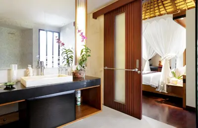 a bathroom with a large sink and a bed at Sunset Paradise Villa Jimbaran 8008 in Jimbaran