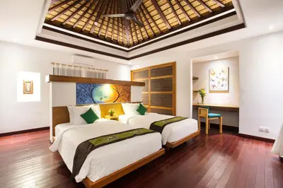 two beds in a bedroom with a ceiling at Sunset Paradise Villa Jimbaran 8008 in Jimbaran