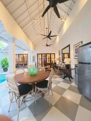 a dining room with a table and chairs at Villa Antiga 2 in Seminyak
