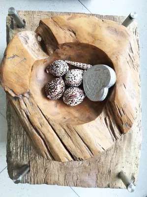 a wooden plate with eggs and a coin on it at Flora Apartment Bali in Seminyak