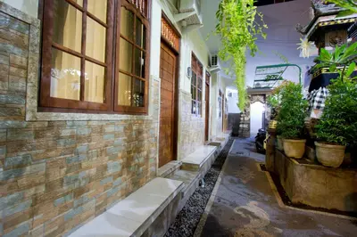 an alley with potted plants on the side of a building at Asta House in Kuta