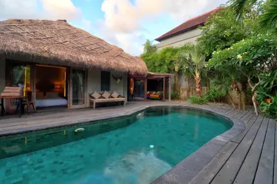 a villa with a swimming pool and a resort at Villa Sham in Seminyak