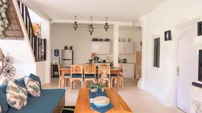 a kitchen and living room with a table and chairs at Villa Alam Biru Gardenia in Seminyak