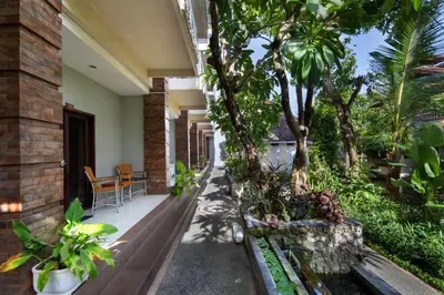 a porch of a house with trees and plants at Legian Village Beach Resort - CHSE Certified in Legian