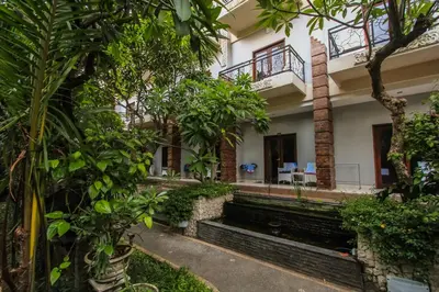 a building with trees in front of it at Legian Village Beach Resort - CHSE Certified in Legian