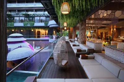 a hotel lobby with a pool and a restaurant at The Crystal Luxury Bay Resort Nusa Dua in Nusa Dua