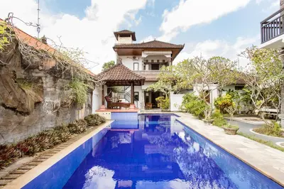 an exterior view of a house with a swimming pool at Rumah Akira Seminyak in Seminyak