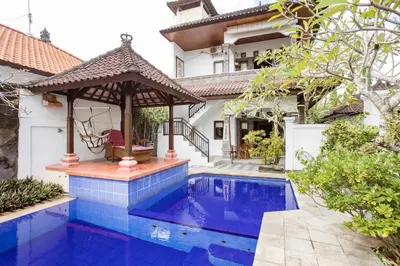a house with a swimming pool and a gazebo at Rumah Akira Seminyak in Seminyak