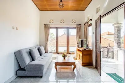 a living room with a couch and a table at Rumah Akira Seminyak in Seminyak