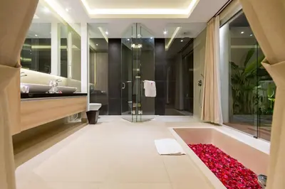 a bathroom with a bath tub and a sink at Sithala Villa Seminyak in Seminyak