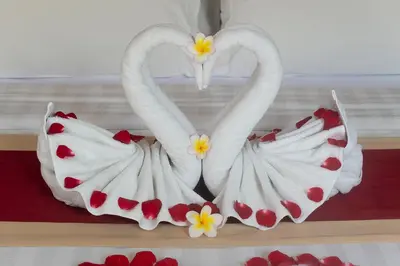 two swans shaped like hearts are sitting on a shelf at Sithala Villa Seminyak in Seminyak