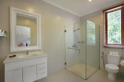 a bathroom with a shower and a sink and a toilet at Villa Lamac in Legian