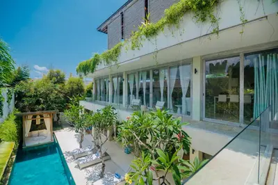 an external view of a house with a swimming pool at Bali Villa Beachfront Luxe Rooftop Sunsets in Canggu