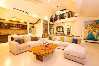 a large living room with couches and a table at Villa Aveli Seminyak by Best Deals Asia Hospitality in Seminyak