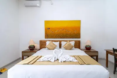 a bedroom with a bed with two towels on it at Villa Aveli Seminyak by Best Deals Asia Hospitality in Seminyak