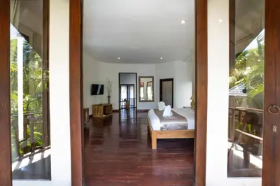 an open door to a bedroom with a bed at Villa Aveli Seminyak by Best Deals Asia Hospitality in Seminyak