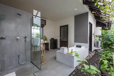 a bathroom with a shower and a walk in shower at Villa Roku by Nagisa Bali in Seminyak