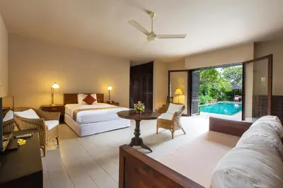 a bedroom with a bed and a living room at Villa Roku by Nagisa Bali in Seminyak