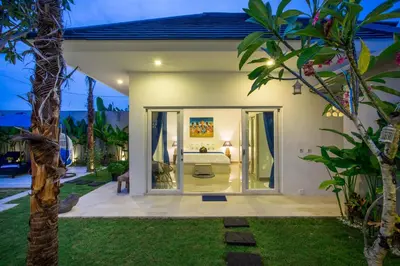 a bedroom in a villa at night at Holyfat Villa in Seminyak