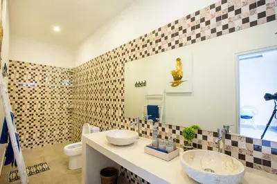 a bathroom with a sink and a mirror at Holyfat Villa in Seminyak