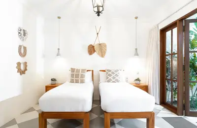 two white chairs in a room with a window at Villa Wahah in Seminyak