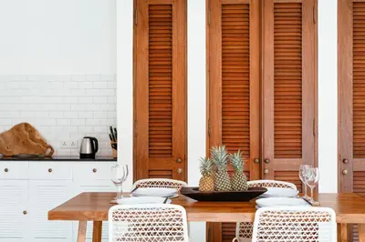 a dining room with a wooden table and chairs at Villa Wahah in Seminyak