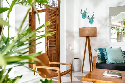 a living room with a chair and a table at Villa Wahah in Seminyak