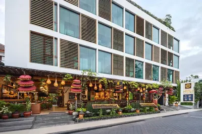 a store front of a building with flowers and plants at Rama Residence Padma in Legian