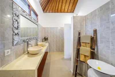 a bathroom with two sinks and a mirror at Villa Mangga 3 chambres seminiak in Seminyak