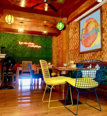 a dining room with chairs and a table in a restaurant at Seahouse Bali Indah Beach Inn in Kuta