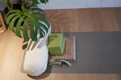 a plant in a white vase sitting on a floor at Seahouse Bali Indah Beach Inn in Kuta