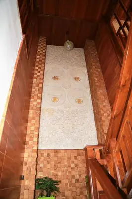an overhead view of a bed in a room at Seahouse Bali Indah Beach Inn in Kuta