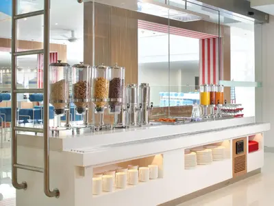 a restaurant with a counter filled with food at Holiday Inn Express Baruna by IHG in Kuta