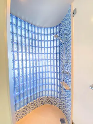 a shower with a blue tile wall in a bathroom at Holiday Inn Express Baruna by IHG in Kuta