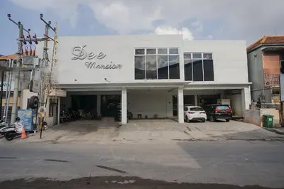 a white building with the words see miracles on it at Dee Mansion Bali in Denpasar