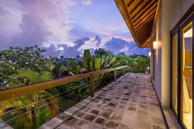 a balcony with a view of a garden at Bali Villa Lotus in Seminyak