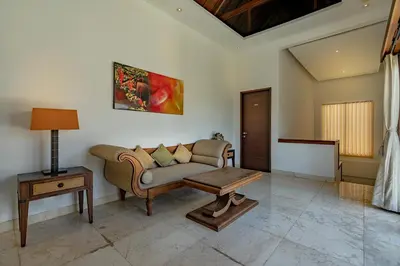 a living room with a couch and a table at Bali Villa Lotus in Seminyak