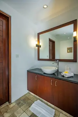 a bathroom with a sink and a large mirror at Bali Villa Lotus in Seminyak