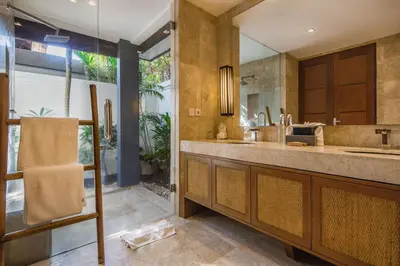 a bathroom with a large sink and a large mirror at Villa Dee 6 in Seminyak