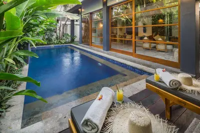 a swimming pool in the middle of a house at Villa Dee 6 in Seminyak