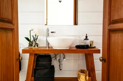 a bathroom with a sink on a wooden table at Villa Tsuchi in Seminyak
