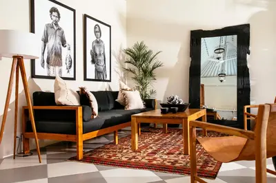 a living room with a black couch and a table at Villa Tsuchi in Seminyak