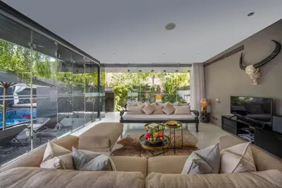 a living room with a couch and a table at Villa Balimu Seminyak in Seminyak