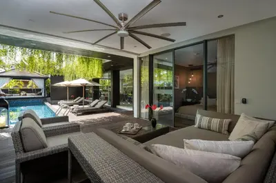 a living room with a couch and a ceiling fan at Villa Balimu Seminyak in Seminyak
