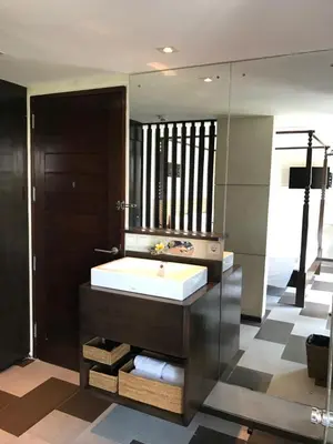 a bathroom with a tub and a large mirror at Anshel Hotel Seminyak in Seminyak
