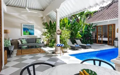 a villa with a swimming pool and a patio at Villa Alliv in Seminyak