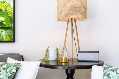 a table with a lamp on it next to a couch at Villa Alliv in Seminyak