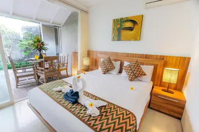 a bedroom with a bed with stuffed animals on it at White Villa in Seminyak